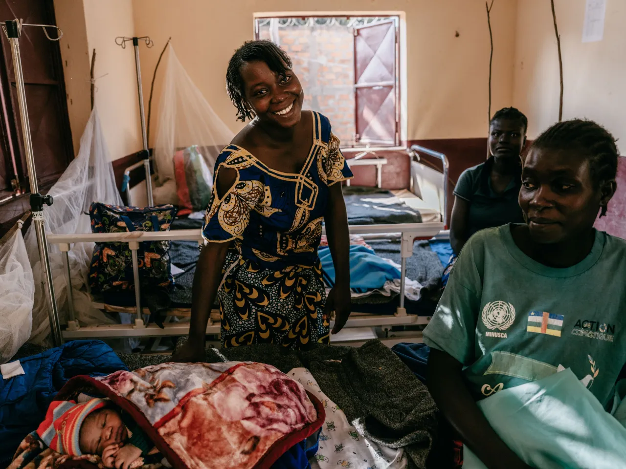 Elise Mbeti who recently gave birth at Doukouma health centre. Elise is a farmer and mother of 3, and has not yet named her new baby. Elise was previously displaced by fighting in the area, and remembers taking refuge in the bush. She has been able to return to her home village, and brings her children to the ICRC health centre of Doukouma when they fall ill. Doukouma, Central African Republic, 9th December 2024.