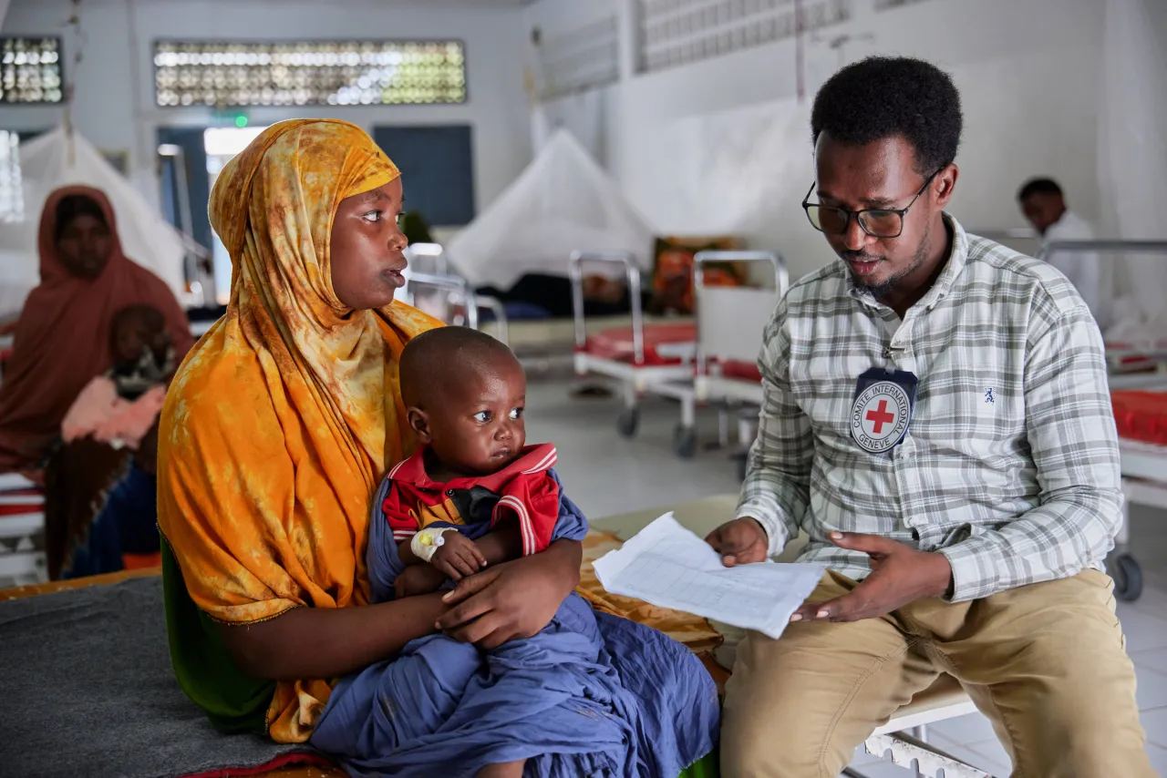 stabilization centre in Kismayo General Hospital ICRC Health Field Officer Mohamed Said Egal reviews a patient’s medical chart at the stabilization centre in Kismayo General Hospital.