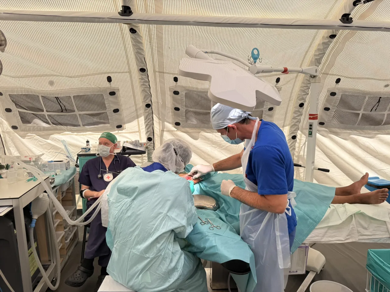 Inside OT with surgeon Dr Ando Kohei, OT Nurse Haitam Al-Hasan, and Anesthetist Dr Hamish Hay - Gaza field hospital