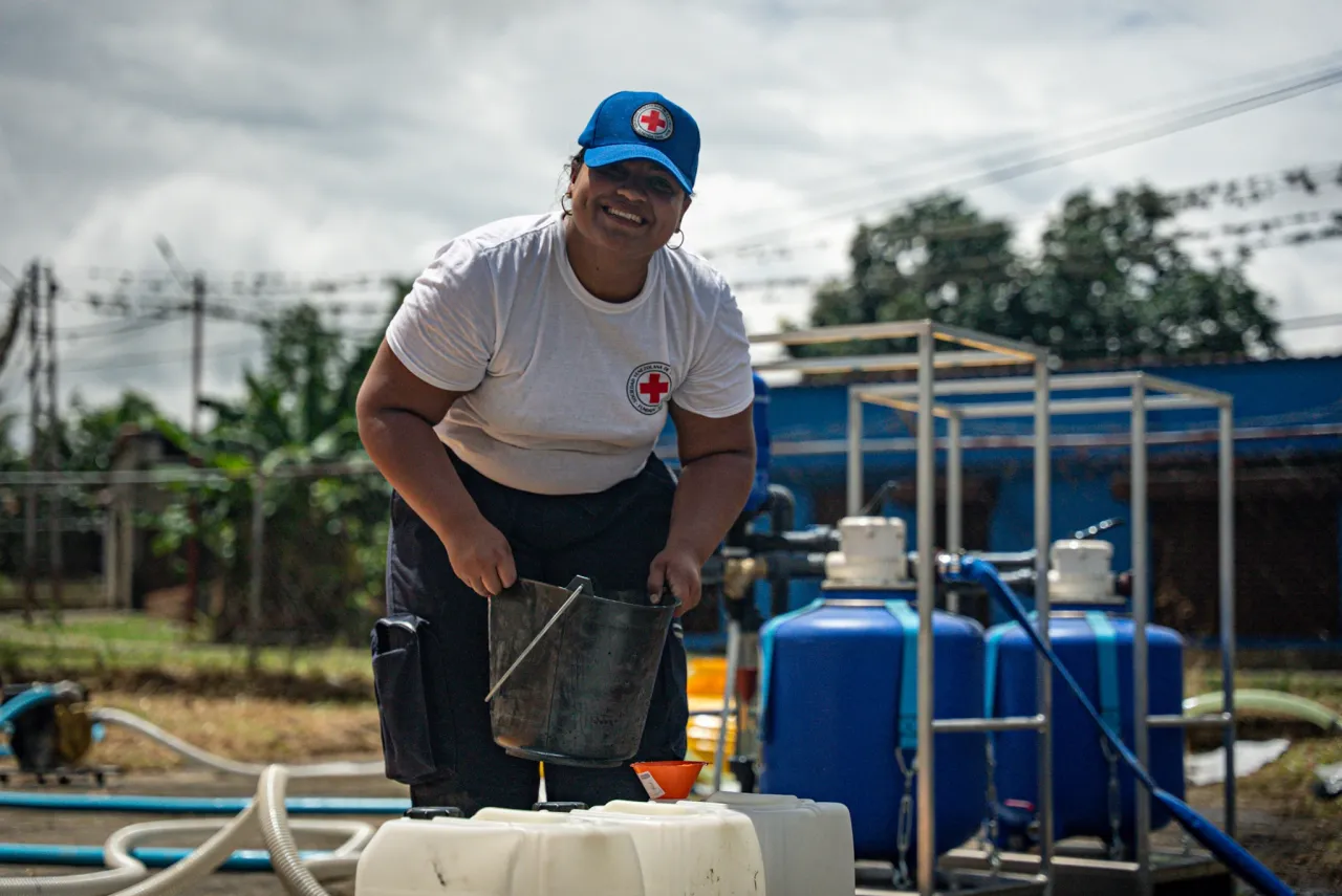 A Venezuelan Red Cross volunteer helps install a water treatment plant in Barinas to supply clean water to more than 600 families after heavy rains in September 2025.