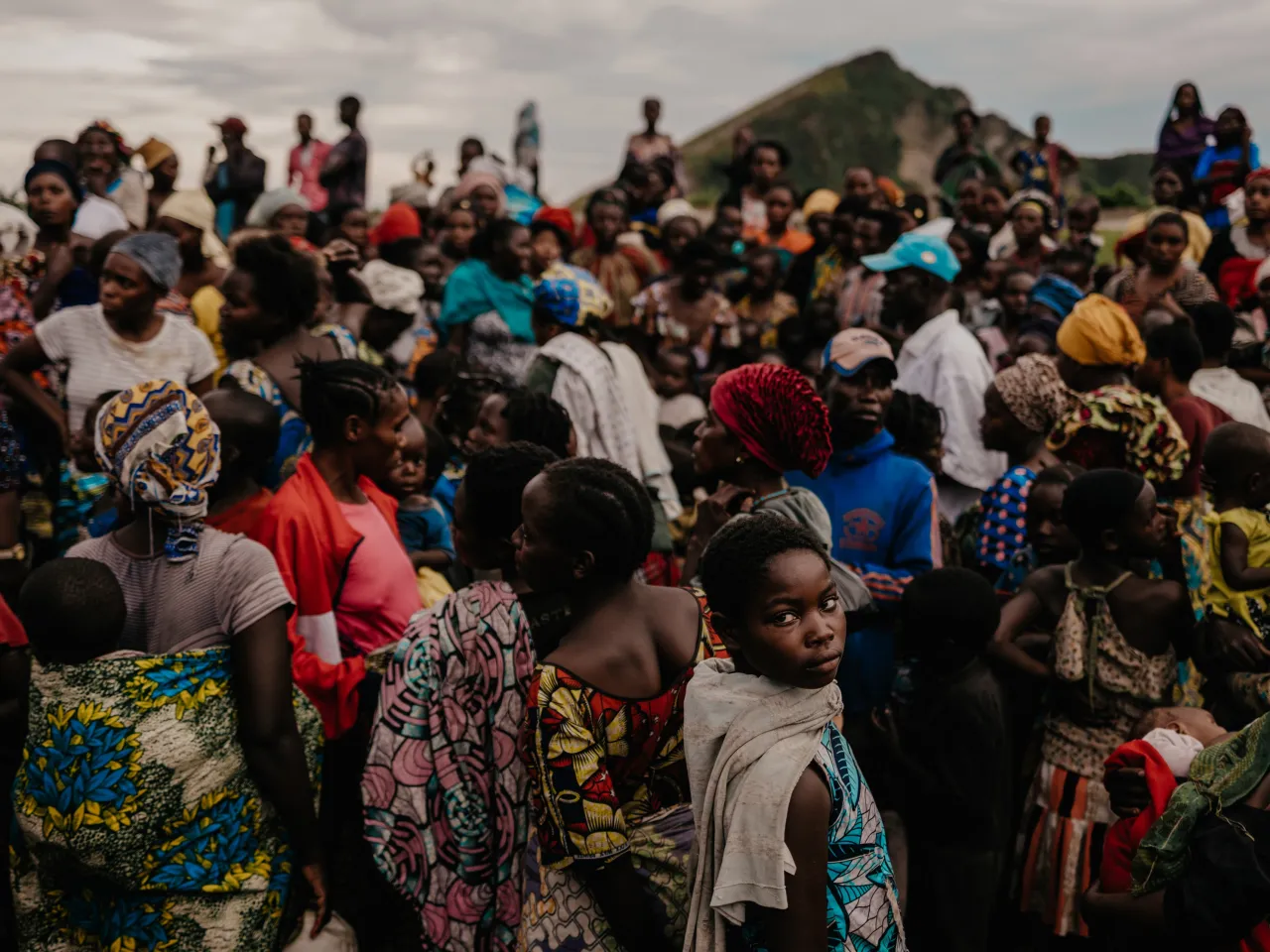 Civilians wait for a food distribution at the Lac Vert displacement camp. 
