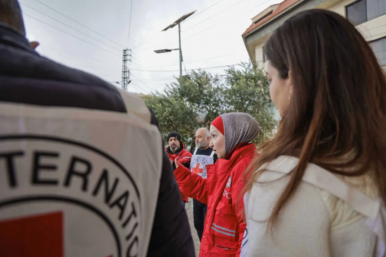 ICRC and Red Crescent staff stand together at a water infrastructure site in Lebanon, coordinating efforts to improve and maintain access to clean water for local communities.