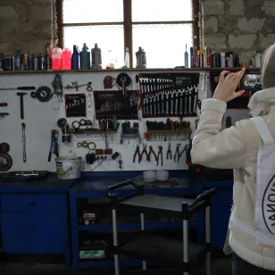 An ICRC staff takes a photo of an auto service workbench.