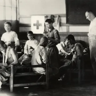 Daegu, POW Camp No. 100. An ICRC delegate Frédéric Bieri with the injured in the infirmary established by the ICRC (26 July 1950)