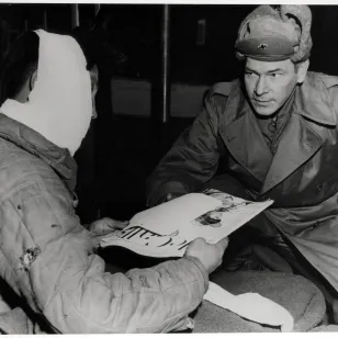 Near Chuncheon. The assistant director of the Red Cross of the U.S. IX Corps distributes Red Cross gifts in a Korean hospital (2 March 1952)