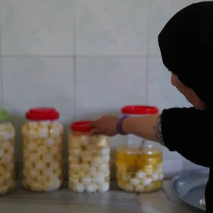 Anoud reaching for jars of food