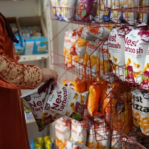 A woman browsing shelves of food