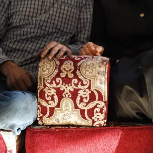A shot of Abu and Umm's hands resting beside each other