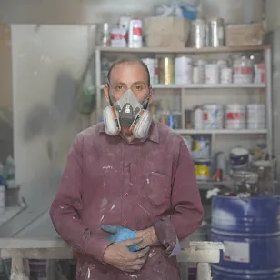 Abu in his carpentry workshop looking directly at the camera