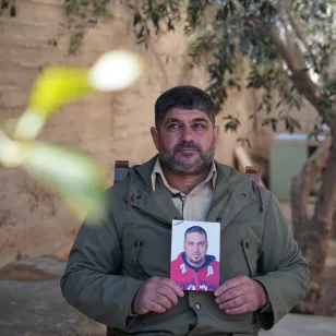 A man holds his brother's picture