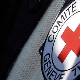 An image shows the emblem of the International Committee of the Red Cross