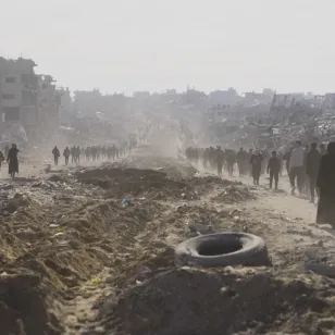 People walking along a dusty road