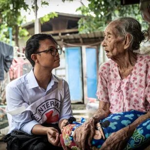 An ICRC worker with an elderly woman in Myanmar
