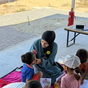 Dr Sally taking children through recreational activities to support mental health at the Gaza Field Hospital.jpg