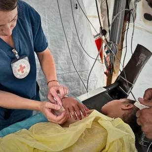 ICRC phsyiotherapist, Rieke Hayes, with a patient at the Red Cross Field Hospital in Rafah