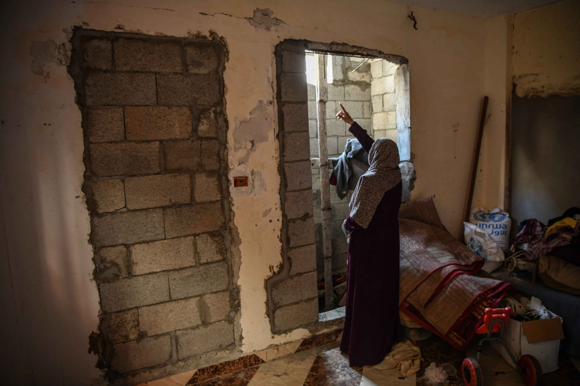 Hanan standing in Mohammed’s bedroom, which is still waiting for him to return and finish rehabilitating it.
