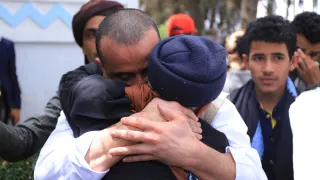 People embrace and shed tears during a prisoner release operation in Yemen, facilitated by the ICRC as a neutral intermediary.