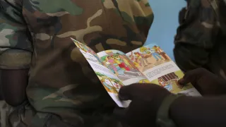 A soldier reads a brochure on IHL for military forces.