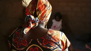 An ICRC staff member listens to the story of a woman who experienced depression after her husband was killed by an armed group. 