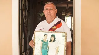 El señor Héctor sostiene el retrato de su esposa fallecida y su hoja desaparecida