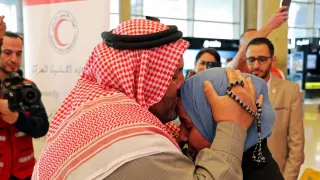 A Syrian refugee takes his missing daughter in his arms and kisses her on the forehead