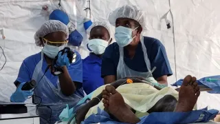 Surgeons treating a patient