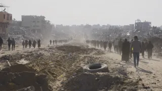 People walking along a dusty road