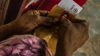 A woman's hands holding a picture of a missing loved one. ICRC