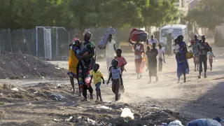 People flee their neighbourhoods amid clashes between the Rapid Support Forces and the Sudanese Armed Forces in Khartoum on April 19, 2023, following the collapse of a 24-hour truce