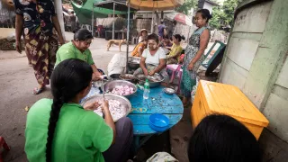 Sagaing, Myanmar, women cooking together in community kitchen 