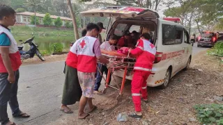 Un equipo de emergencia de la Cruz Roja de Myanmar carga a un herido en una camilla dentro de una ambulancia tras el terremoto de Myanmar, prestando ayuda médica urgente.