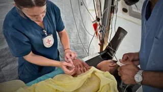 ICRC phsyiotherapist, Rieke Hayes, with a patient at the Red Cross Field Hospital in Rafah