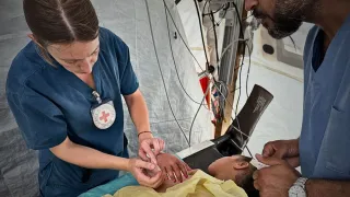 ICRC phsyiotherapist, Rieke Hayes, with a patient at the Red Cross Field Hospital in Rafah
