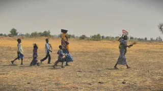 A displaced family gleaning rice in Usur village
