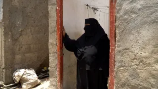 Arwaa stands in the doorway