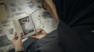 Hala from Anbar, holding the picture of her missing loved one.