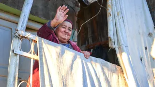 Manana (75) at the front door of her house greeting ICRC staff