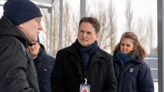 ICRC Director-General Pierre Krähenbühl speaks with a local resident outdoors in a winter setting, accompanied by a colleague.