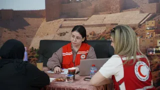 ICRC and Jordan Red Crescent Society PFL officers speaking with one of the families of missing persons, explaining the services and support that the ICRC can provide to these families.