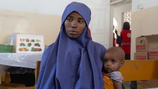 Nurta Ibrahim, 25, with her daughter, Salaada Mohamed at the Somali Red Crescent-run Howlwadaag outpatient therapeutic centre seeking treatment.