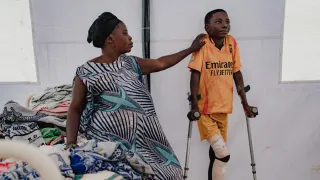 Adela Yang and her son Ebwela Liko at Fizi general hospital.  Adela’s son is 14 years old, and was hit by a bullet in the leg whilst he was sheltering at home from fighting in his home village of Kaguli. “We were hiding at home, but he stood up to run away, and so was hurt by a bullet. Others in the village, including his teacher came and helped carry him to the health centre. It was 5 kilometres away. We stayed there for 1 week while they stabilised him. A CICR ambulance brought him to the