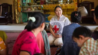 Conducting an ICRC informative session during an aid distribution at Patheingyi Island, Mandalay Region.