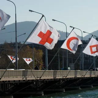 Flags fly at the Mont-Blanc bridge in Geneva, marking the 30th International Conference of the Red Cross and Red Crescent.