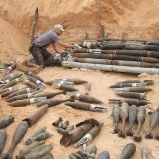 ICRC clearance team leader prepares unexploded devices for demolition. Copyright ICRC