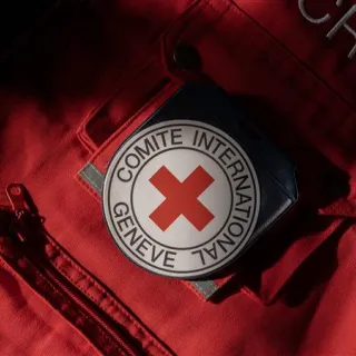 Close-up of red ICRC vest with ICRC emblem on the pocket