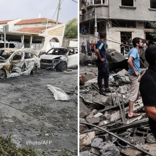 Pessoas estão diante de edifícios destruídos.