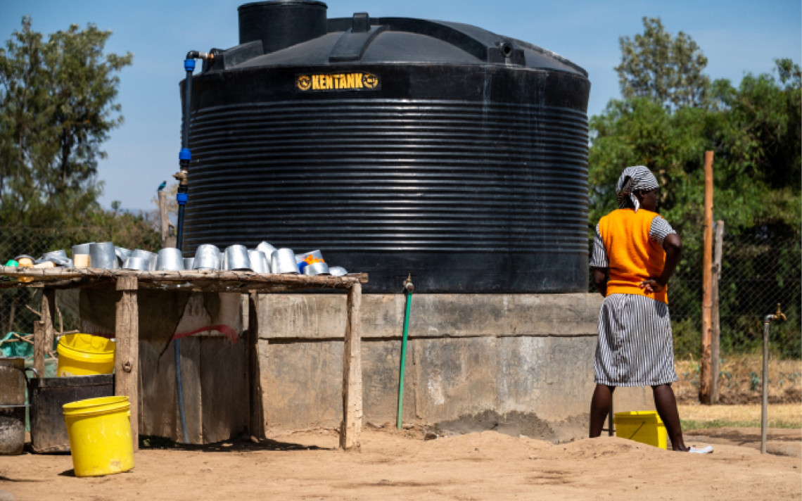 An inmate at Naivasha Women's prison in Kenya fetches water from one of the cleaning areas