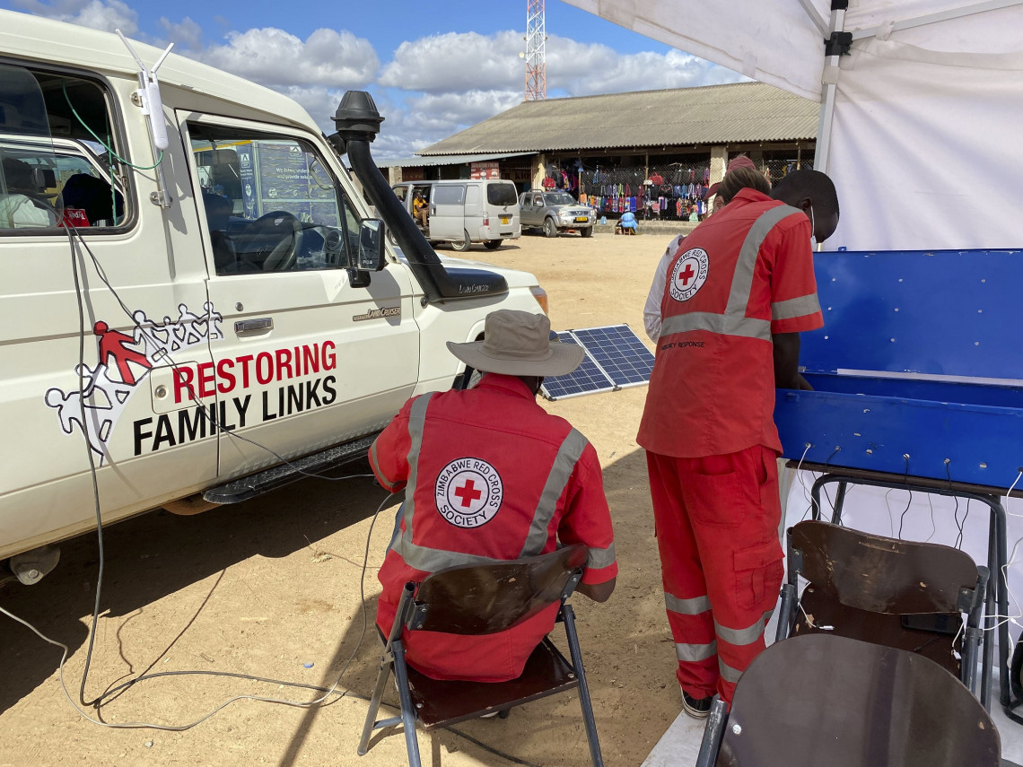 Volunteers of the Zimbabwe Red Cross Society (ZRCS) setting up the equipment to provide services in their mobile kiosk. Photo: Berta PANES/ICRC