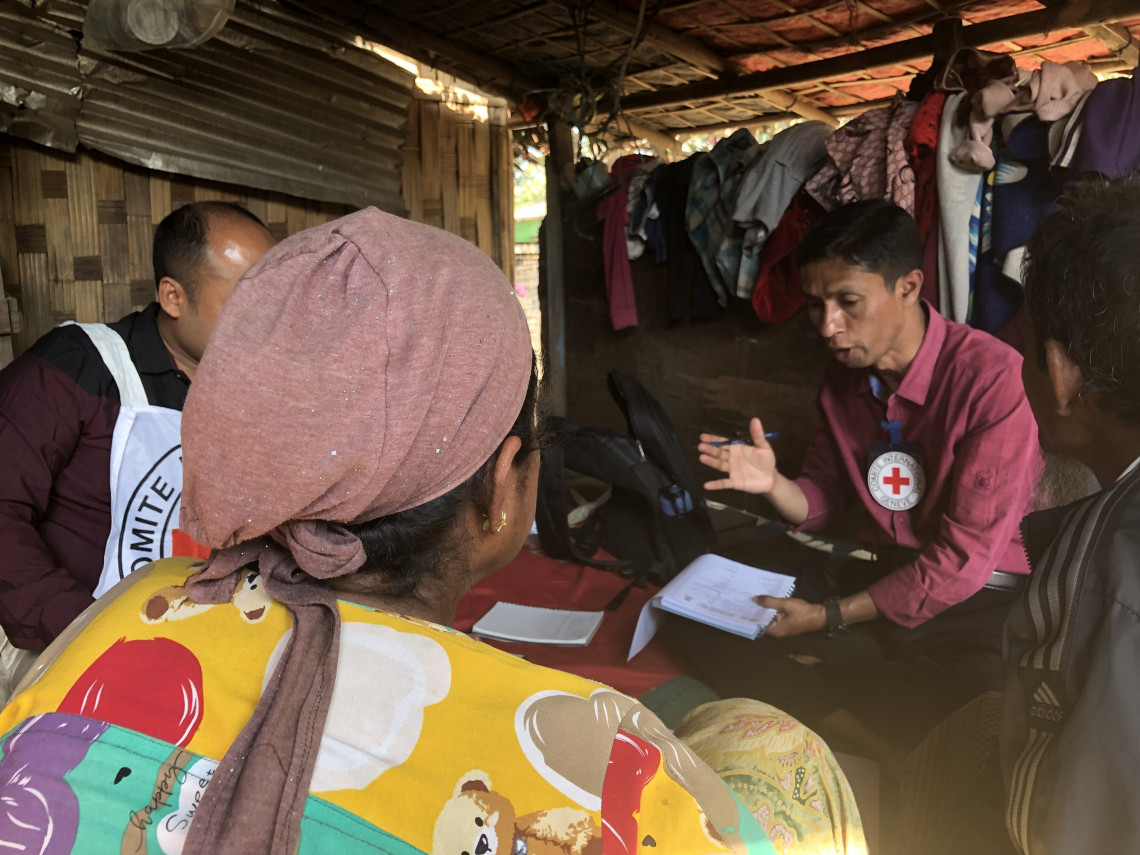 During the first home visit, ICRC staff members explain how they can help Daw Be Be.