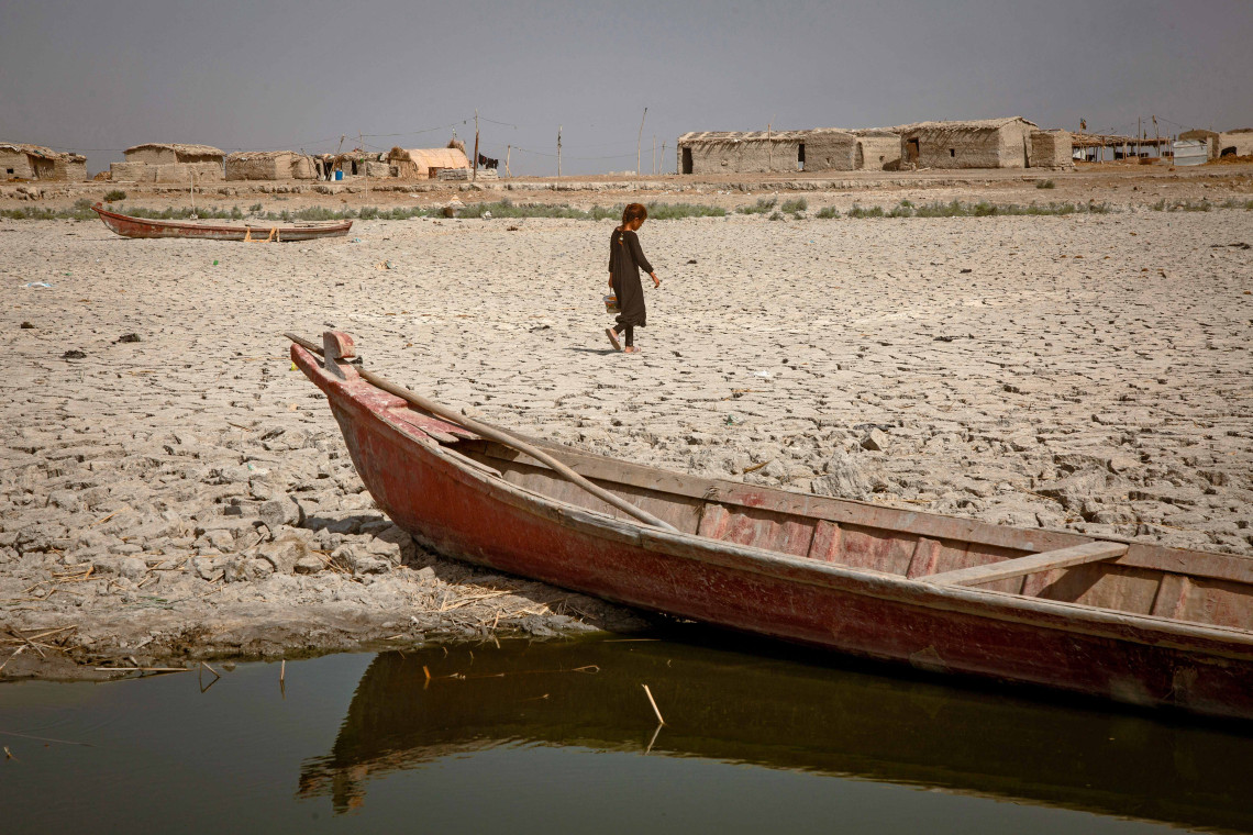 A girl in Jabayesh searches for water. She leaves her home looking for any remaining water sources following the drought.